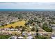 Wide aerial view of a residential area with a large lake and the ocean in the distance on a sunny day at 4375 Tortoise Rd, Venice, FL 34293