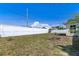 Backyard with white fence and garden beds, offering both beauty and privacy at 4375 Tortoise Rd, Venice, FL 34293