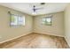 Empty bedroom features light-colored walls, wood-look floor, and dual windows at 4375 Tortoise Rd, Venice, FL 34293
