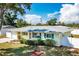 Attractive single-story home with a well-manicured lawn, white fence, and lush landscaping at 4375 Tortoise Rd, Venice, FL 34293