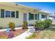 Charming home featuring a well-kept garden, sidewalk to front door, and a lovely porch at 4375 Tortoise Rd, Venice, FL 34293