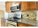 Kitchen with stainless steel oven and microwave and light brown cabinets at 4375 Tortoise Rd, Venice, FL 34293
