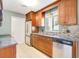 Well-lit kitchen featuring stainless steel appliances, tile backsplash, and granite countertops at 4375 Tortoise Rd, Venice, FL 34293