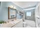 Charming bathroom with vintage light-blue colored walls, with plenty of storage and natural light at 4535 Maceachen Blvd, Sarasota, FL 34233