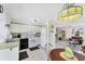 Traditional kitchen with white cabinets and appliances, complemented by a dining area at 4535 Maceachen Blvd, Sarasota, FL 34233