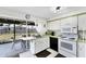 Functional kitchen featuring white cabinets, laminate countertops, and backyard view at 4535 Maceachen Blvd, Sarasota, FL 34233