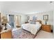 Bright main bedroom featuring a queen-sized bed, classic décor, and exterior access at 4535 Maceachen Blvd, Sarasota, FL 34233