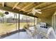 Enclosed patio with seating area and fan, perfect for enjoying the outdoors at 4535 Maceachen Blvd, Sarasota, FL 34233