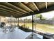 Enclosed patio with seating area and a view of the backyard and fence at 4535 Maceachen Blvd, Sarasota, FL 34233