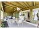 Enclosed patio with seating area, fan and connection to the kitchen, perfect for enjoying the outdoors at 4535 Maceachen Blvd, Sarasota, FL 34233