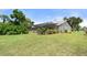 Lush backyard with a screened-in pool enclosure and manicured landscaping, offering privacy and charm at 4622 34Th E Ct, Bradenton, FL 34203