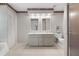 Well-lit bathroom with dual sinks, neutral color palette, and a glass-enclosed shower at 4622 34Th E Ct, Bradenton, FL 34203