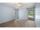 Light-filled bedroom with wood floors, sliding doors to the outside, and neutral-colored walls at 4622 34Th E Ct, Bradenton, FL 34203