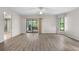 Bright living room boasts wood floors, sliding glass doors to the outside, and two windows at 4622 34Th E Ct, Bradenton, FL 34203