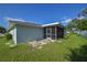 A fenced-in backyard with a screened-in porch and green grass at 478 Orange Nw Dr, Port Charlotte, FL 33952