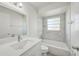 Bathroom featuring updated vanity, shower, tub, and tile with a large mirror and modern fixtures at 478 Orange Nw Dr, Port Charlotte, FL 33952