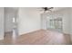 Bedroom with wood-look flooring, ceiling fan, slider to the patio and an ensuite bath at 478 Orange Nw Dr, Port Charlotte, FL 33952