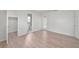 Bedroom with laminate wood flooring, access to a walk-in closet, bathroom, and outdoor deck at 478 Orange Nw Dr, Port Charlotte, FL 33952