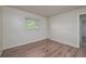 Bright bedroom featuring new laminate flooring, neutral paint, and one window at 478 Orange Nw Dr, Port Charlotte, FL 33952