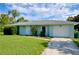 Charming single-story home with a well-manicured lawn and attached one car garage at 478 Orange Nw Dr, Port Charlotte, FL 33952