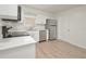 Modern kitchen featuring white cabinets, stainless steel appliances, and new wood-look flooring at 478 Orange Nw Dr, Port Charlotte, FL 33952