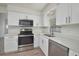 Updated kitchen featuring stainless steel appliances, quartz countertops, and stylish white cabinetry at 478 Orange Nw Dr, Port Charlotte, FL 33952