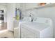 Bright laundry room with washer, dryer, shelving, and access to other parts of the house at 478 Orange Nw Dr, Port Charlotte, FL 33952
