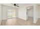 Cozy living room with wood-look flooring, ceiling fan, and sliding doors to backyard at 478 Orange Nw Dr, Port Charlotte, FL 33952