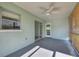 An empty, covered patio featuring a ceiling fan, neutral paint, and sliding glass doors to the backyard at 478 Orange Nw Dr, Port Charlotte, FL 33952