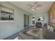 Relaxing covered patio with ceiling fan, neutral paint, and sliding glass doors for indoor/outdoor living at 478 Orange Nw Dr, Port Charlotte, FL 33952