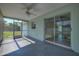 Enclosed lanai with ceiling fan, painted floors, and screen windows with view of backyard at 478 Orange Nw Dr, Port Charlotte, FL 33952