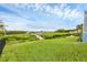 Picturesque backyard with a lush green lawn, leading to a wooden dock and scenic waterfront views at 4844 14Th E Ave, Bradenton, FL 34208