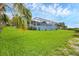 Expansive backyard showcasing a screened pool and lush green lawn leading up to the house at 4844 14Th E Ave, Bradenton, FL 34208