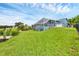 Green backyard featuring a screened pool, lush lawn, and views of the surrounding trees at 4844 14Th E Ave, Bradenton, FL 34208