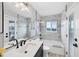 Bright bathroom with double vanity, large mirror, tub and shower combination, and access to the balcony at 4844 14Th E Ave, Bradenton, FL 34208