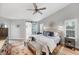 Comfortable bedroom with a vaulted ceiling, a ceiling fan, and access to the bathroom at 4844 14Th E Ave, Bradenton, FL 34208
