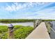 Waterfront home boasts a private boat dock with lush landscaping and clear blue sky at 4844 14Th E Ave, Bradenton, FL 34208