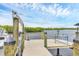 Waterfront home boasts a private boat dock with a bench and boat lift at 4844 14Th E Ave, Bradenton, FL 34208