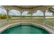 Interior of community gazebo with bench seating overlooking the surrounding water and landscaping at 4844 14Th E Ave, Bradenton, FL 34208