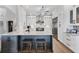 Modern kitchen with white cabinets, gray island, stainless steel appliances, and stylish bar stools at 4844 14Th E Ave, Bradenton, FL 34208