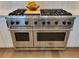 Close up of a modern stainless steel oven and cooktop with countertop at 4844 14Th E Ave, Bradenton, FL 34208