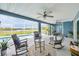 Relaxing screened patio featuring ceiling fans, cozy seating, and views of the pool and waterfront at 4844 14Th E Ave, Bradenton, FL 34208
