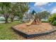 View of a community playground with a slide, climbing equipment, and green spaces at 4844 14Th E Ave, Bradenton, FL 34208