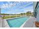 A refreshing screened pool with clear blue water, surrounded by a white fence and lush greenery at 4844 14Th E Ave, Bradenton, FL 34208