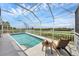 Inviting screened pool area with a chair and table, perfect for relaxing by the water's edge at 4844 14Th E Ave, Bradenton, FL 34208