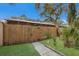 View of the backyard featuring a tall wooden fence and green grass at 500 N Jefferson Ave # G5, Sarasota, FL 34237