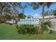 Jefferson Club signage amidst lush greenery, creating an inviting neighborhood entrance under a sunny sky at 500 N Jefferson Ave # G5, Sarasota, FL 34237
