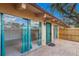 Home exterior featuring a brick patio, sliding glass doors, and vibrant turquoise trim at 500 N Jefferson Ave # G5, Sarasota, FL 34237