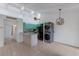 Bright open-concept space with tiled floor, kitchen, and laundry at 500 N Jefferson Ave # G5, Sarasota, FL 34237
