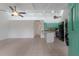 Spacious living room with white walls, tile floor, and open access to kitchen at 500 N Jefferson Ave # G5, Sarasota, FL 34237
